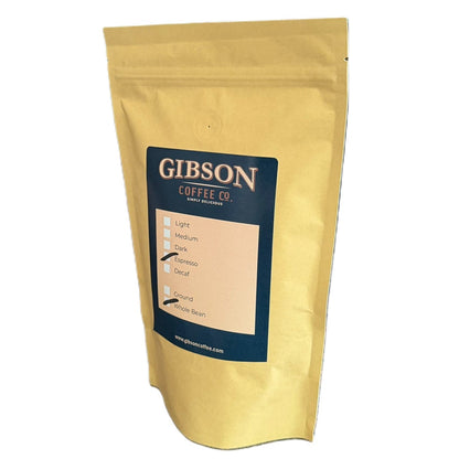 Brown kraft coffee bag with a blue Gibson Coffee Co. label marked Espresso roast and Whole Bean.